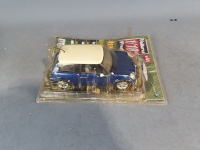 a small toy car in a plastic package on a table