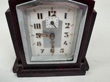 a small clock that is sitting on a table