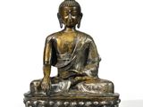 statue of a seated buddha on a lotus - shaped base