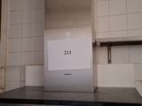 a picture of a stove in a kitchen with a sign on it