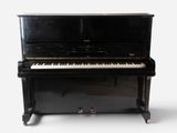 an old black piano sitting on top of a white floor