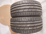 three tires stacked on top of each other on a white surface