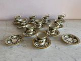 many cups and saucers sitting on a table
