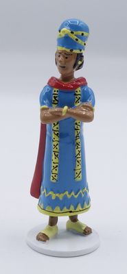 a close up of a figurine of a woman in a blue dress