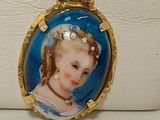 une photo d'une femme en robe bleue portant un collier plaqué or