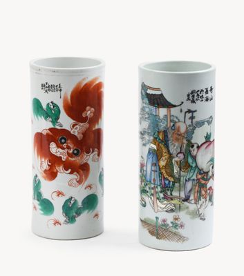 pair of chinese porcelain vases with characters on them on a white background