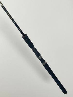 a close up of a fishing rod on a white surface