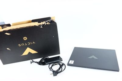 an open box with a laptop and a charger on it