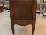 a small wooden cabinet in the middle of a room