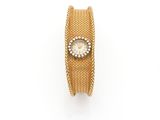 a close up of a watch on a white surface with a white background