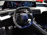 the interior of a car with a steering wheel and a display screen