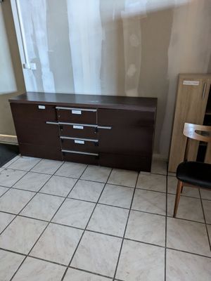 tiled floor in a room with a dresser and chair in it