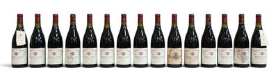 six bottles of wine lined up in a row on a white surface