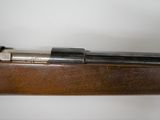 a close up of a rifle on a white surface