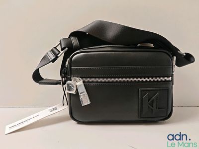 a small black bag with a tag on it