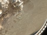 a close up of a silver plate on a table