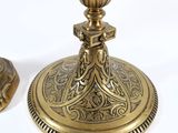 two antique brass candlesticks on a white background with a white background