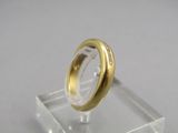a gold ring sitting on top of a clear display case
