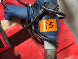 a blue and black electric drill on a red pallet