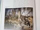 an open book with a picture of a battle on it