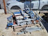 a lot of pipes and other equipment in a parking lot