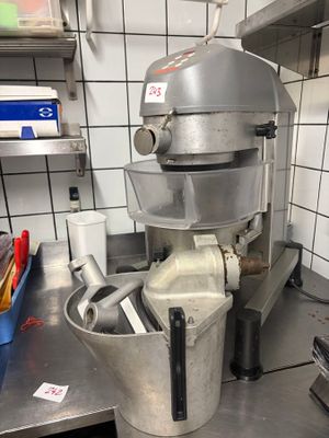 a silver mixer sitting on a counter in a kitchen