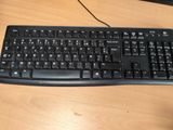 a black keyboard and mouse on a wooden desk