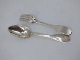 two spoons and a fork sitting on a table