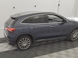 the mercedes gle is parked in a garage with a checkered floor