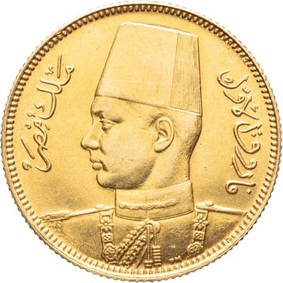 a close up of a gold coin with an image of a man wearing a hat