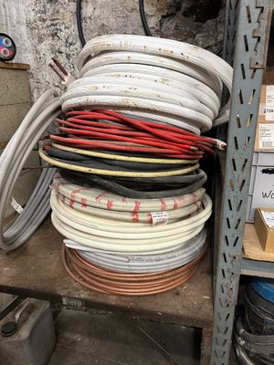 many different types of wires on a shelf in a warehouse