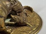 a close up of a brass plate with a dog and a cat on it