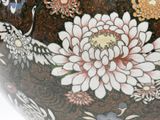 a large vase with flowers painted on it