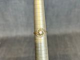 a gold ring sitting on top of a tall metal pole