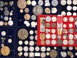 many different types of coins in a display case