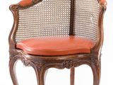 an image of a wooden chair with a red cushion on top of it