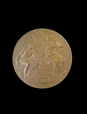gold medal depicting a man on horseback and a woman on a horse