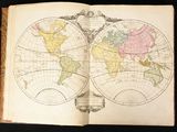 an open book with a map of the world on it