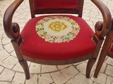 a red chair that has a floral pattern on it
