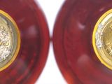pair of red and gold glass vases with gold medallions on them