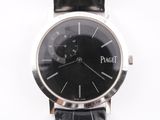 the watch has a black dial on the face of the watch