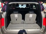 two seats in the back of a car with the trunk open