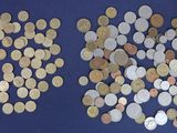 many different types of coins on a blue surface