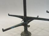 an image of a metal table with four legs and a metal base