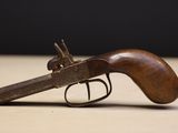 a close up of a gun on a table with a black background