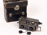 two old cameras sitting next to each other on a white surface