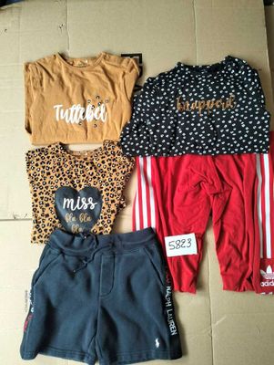 three pairs of clothes on a cardboard box with a price tag