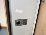 a small safe box in the corner of a cabinet
