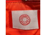a close up of an orange jacket with a white label on it