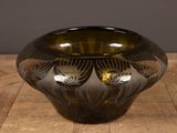 a glass vase with a design on it sitting on a table